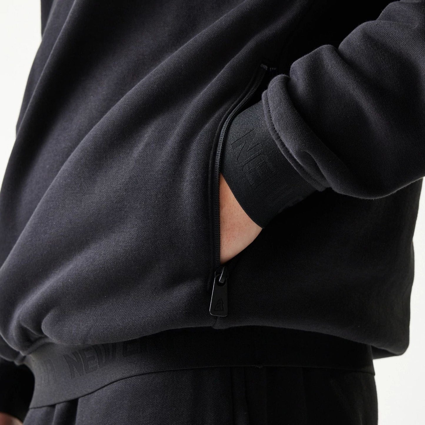 The model is wearing this New Era Tech Oversized Pullover Hoodie in black. 6