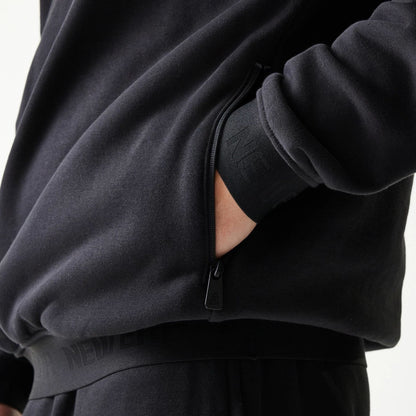 The model is wearing this New Era Tech Oversized Pullover Hoodie in black. 6