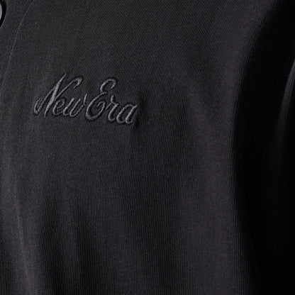The model is wearing this New Era Open Heritage Script T-Shirt in black. 5