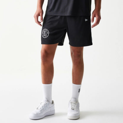 The model is wearing this New Era Football Shorts in black. 1