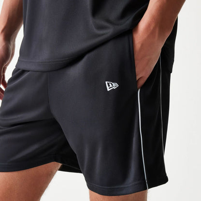 The model is wearing this New Era Football Shorts in black. 5