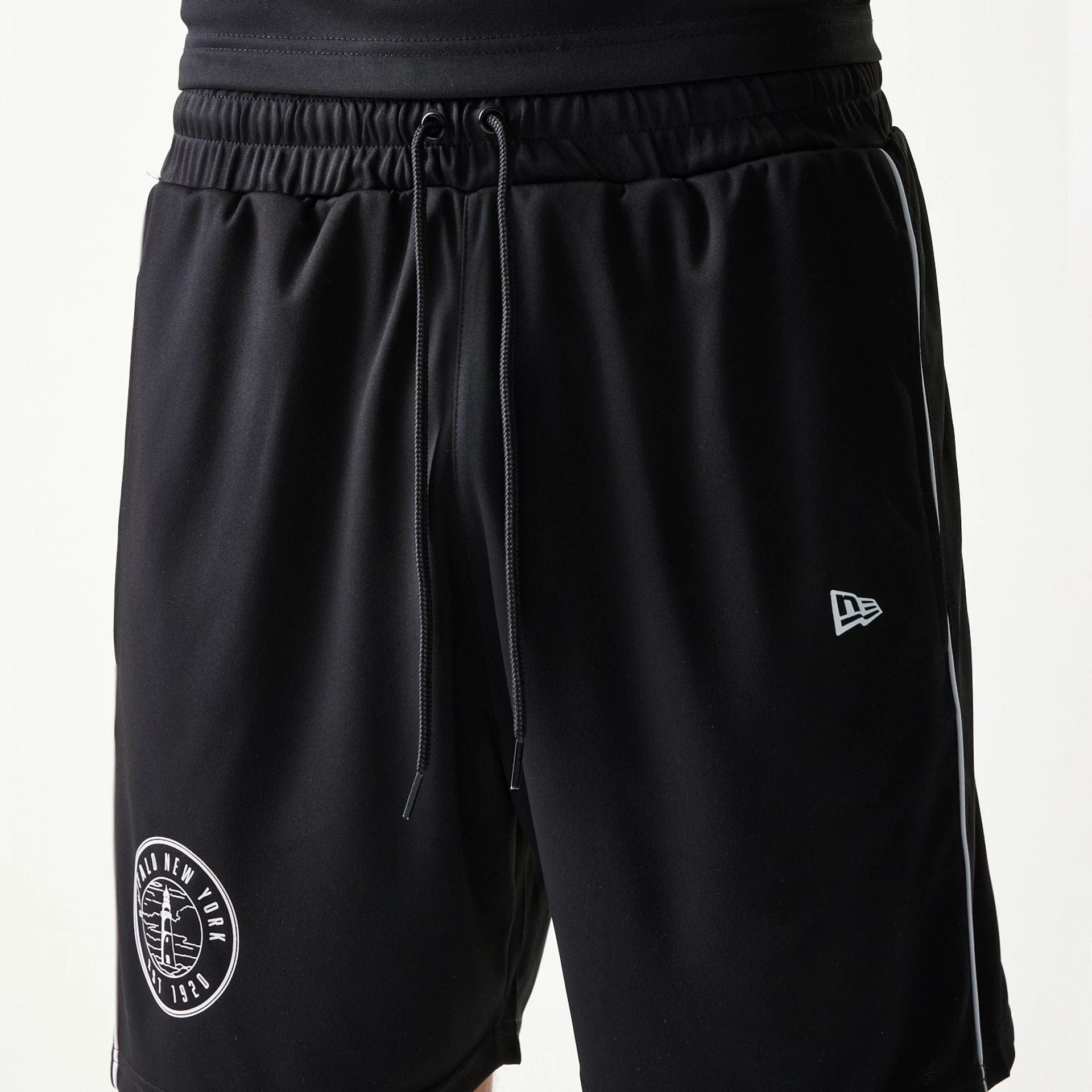 The model is wearing this New Era Football Shorts in black. 6