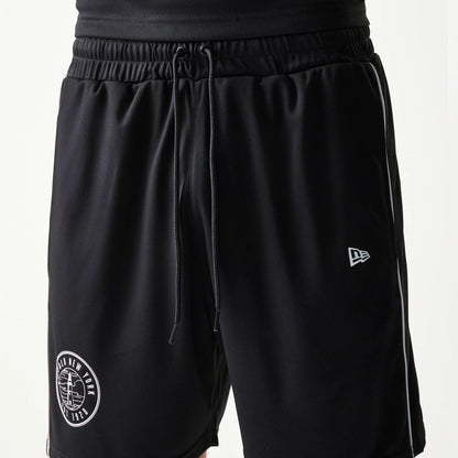 The model is wearing this New Era Football Shorts in black. 6