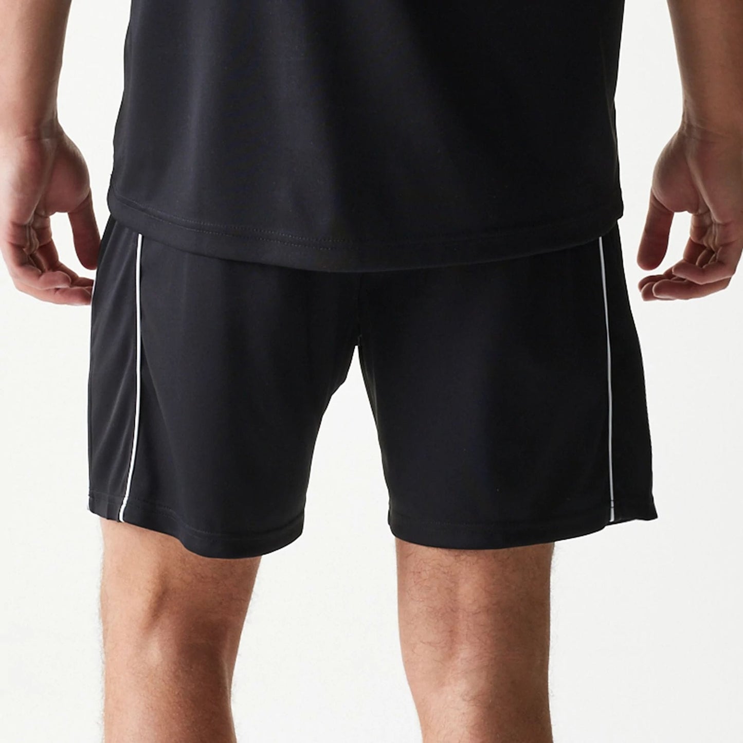 The model is wearing this New Era Football Shorts in black. 7
