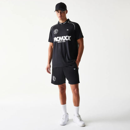 The model is wearing this New Era Football Shorts in black. 8