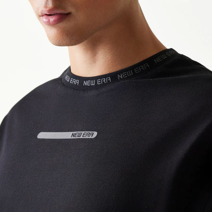 The model is wearing this New Era Tech Oversized T-Shirt in black. 4