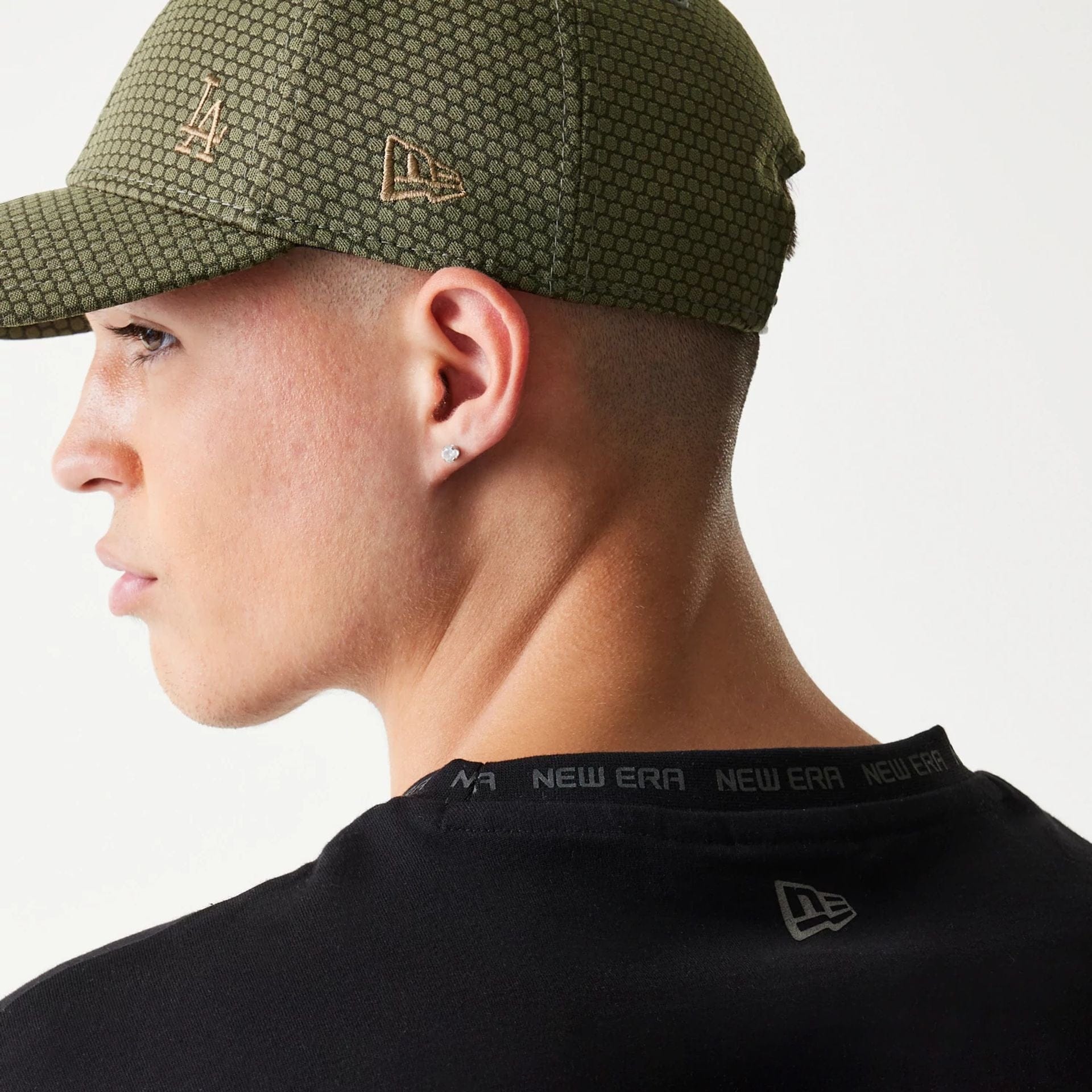 The model is wearing this New Era Tech Oversized T-Shirt in black. 5