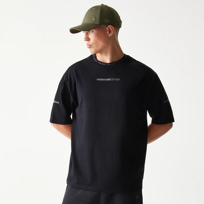 The model is wearing this New Era Tech Oversized T-Shirt in black. 1
