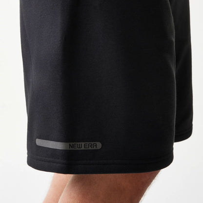 The model is wearing this New Era Tech Shorts in black. 8