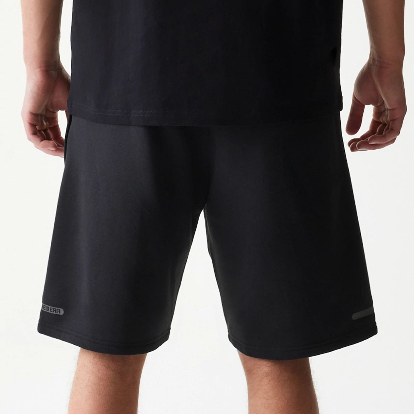The model is wearing this New Era Tech Shorts in black. 6