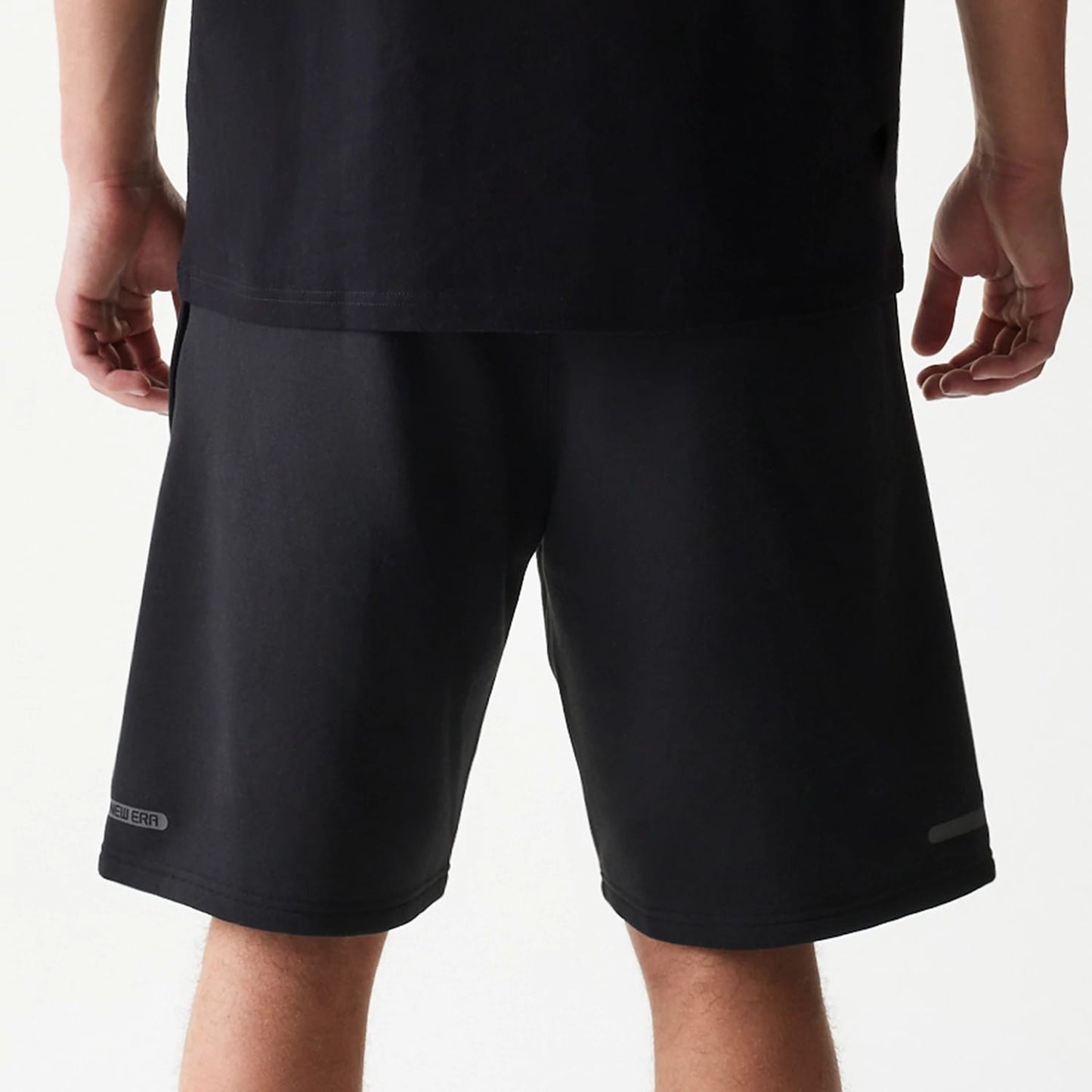 The model is wearing this New Era Tech Shorts in black. 6