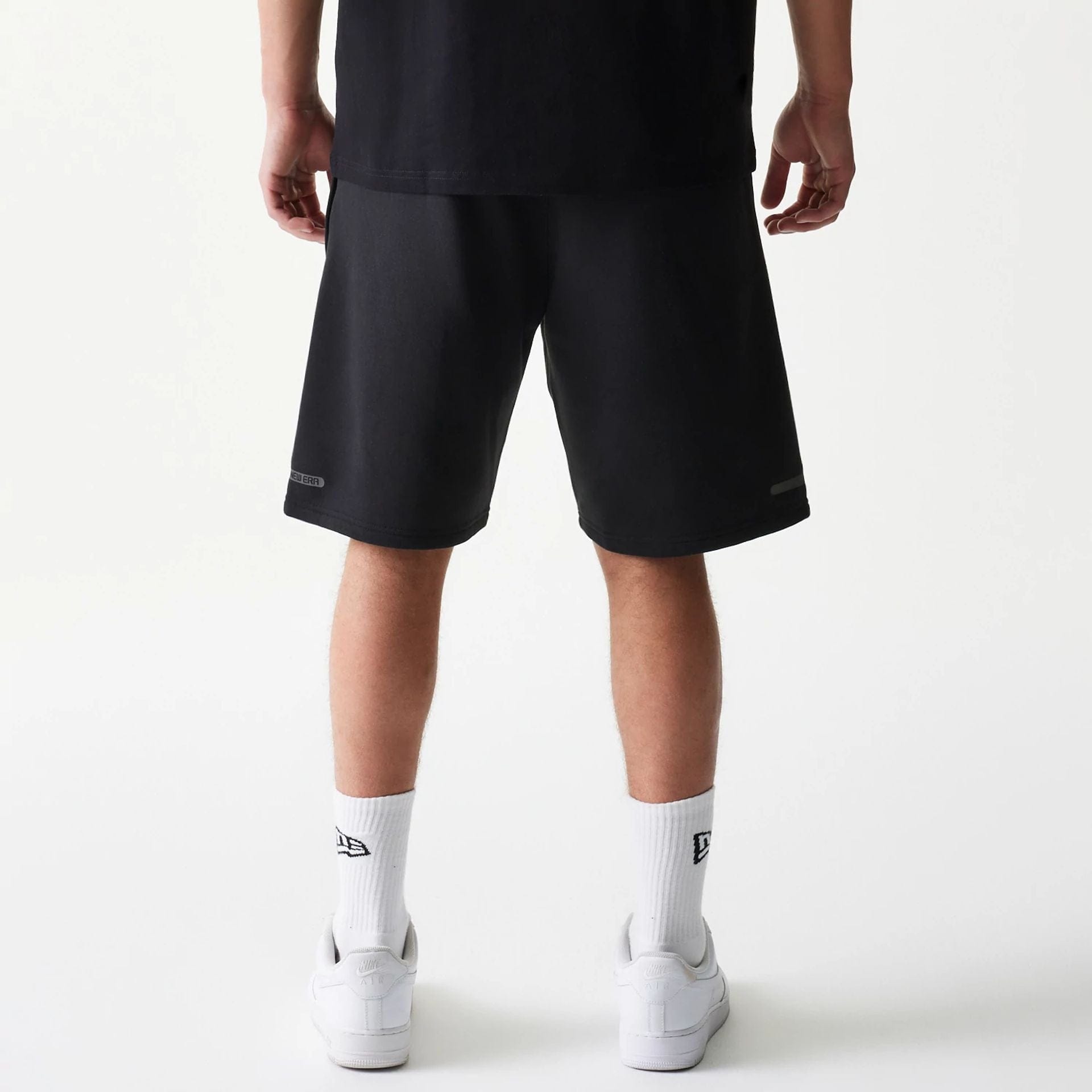 The model is wearing this New Era Tech Shorts in black. 2