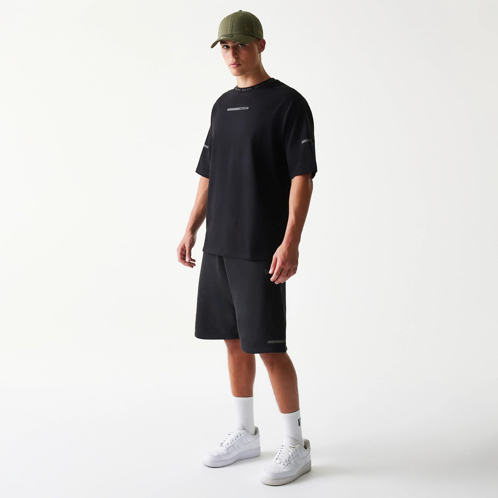 The model is wearing this New Era Tech Shorts in black. 7