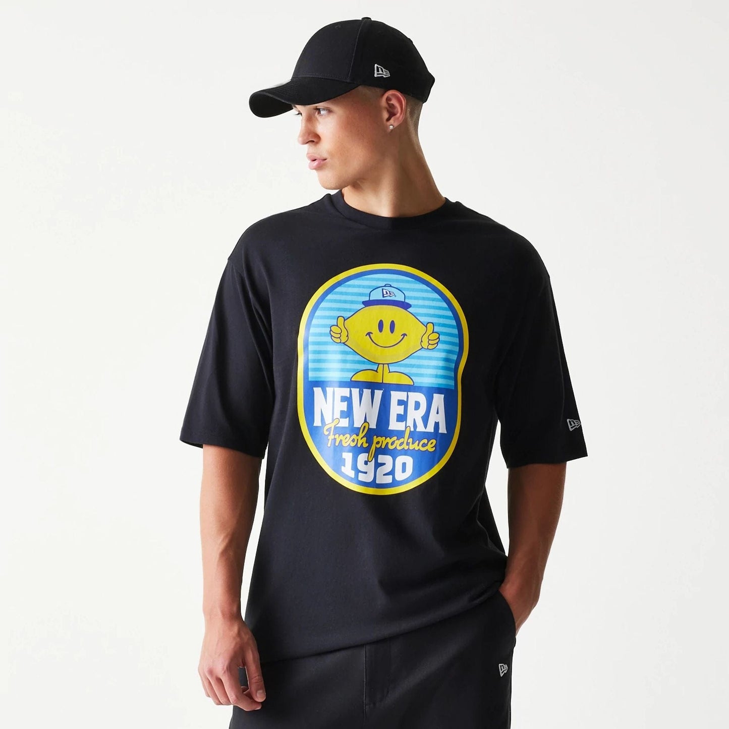 The model is wearing this New Era Lemon Fruit Graphic Oversized T-Shirt in black. 3