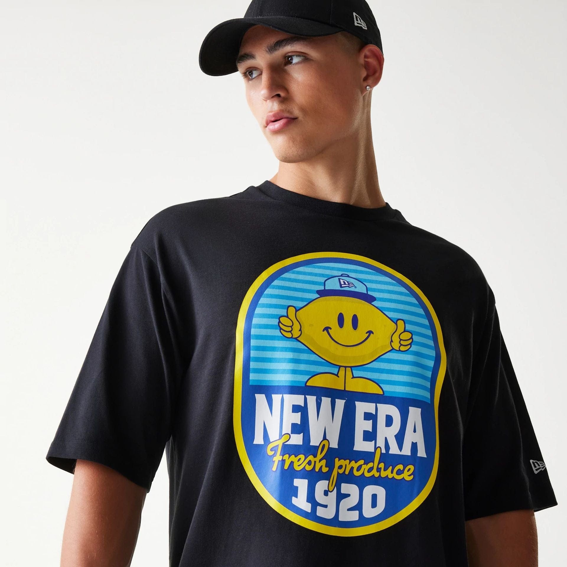 The model is wearing this New Era Lemon Fruit Graphic Oversized T-Shirt in black. 6