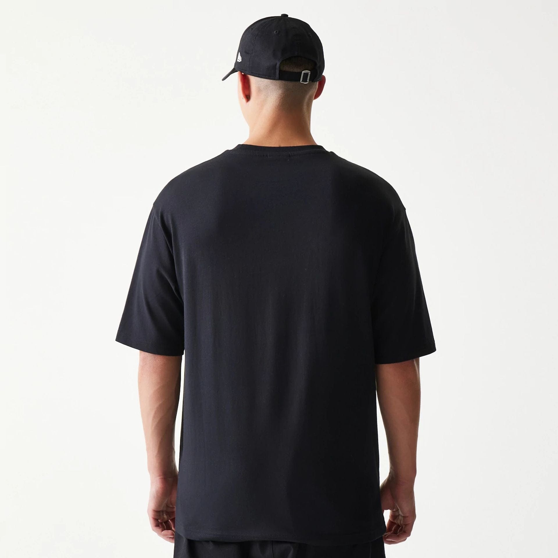 The model is wearing this New Era Lemon Fruit Graphic Oversized T-Shirt in black. 2