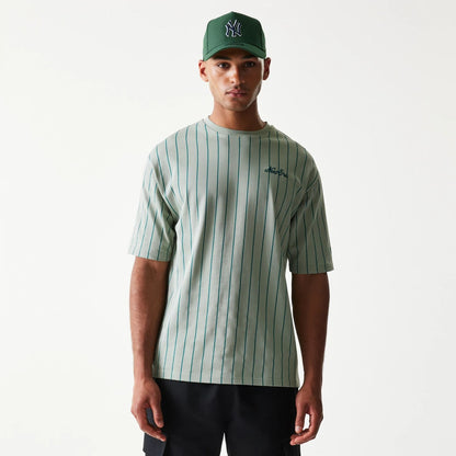 The model is wearing this New Era Pinstripe Oversized T-Shirt in pastel green. 1