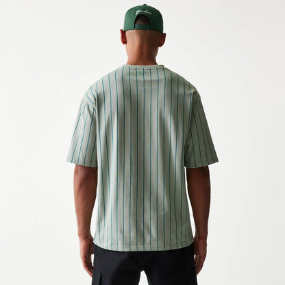 The model is wearing this New Era Pinstripe Oversized T-Shirt in pastel green. 2