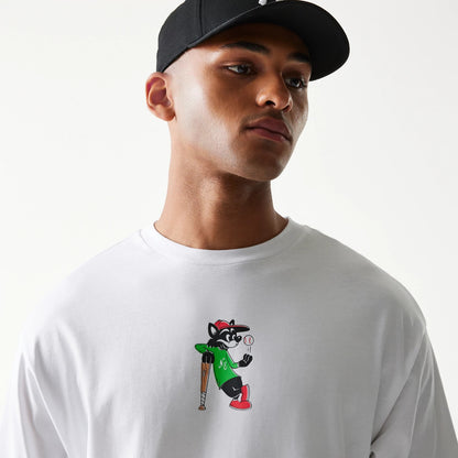 New Era Baseball Cat Character Graphic White Oversized T-Shirt, front view on model wearing a black cap, featuring a colourful printed graphic of a cartoon cat in a green jersey and red shoes leaning on a baseball bat.