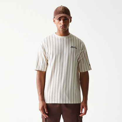 The model is wearing this New Era Pinstripe Oversized T-Shirt in light beige. 3
