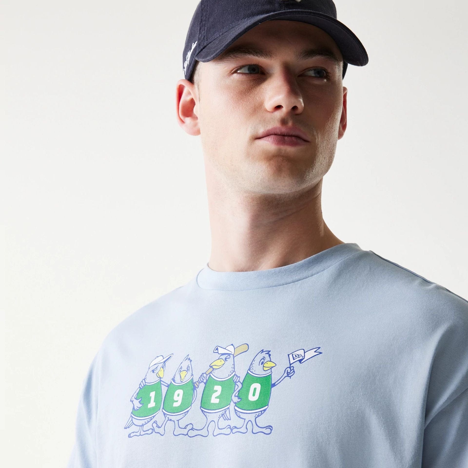 The model is wearing this New Era Baseball Birds Character Graphic Oversized T-Shirt in pastel blue. 5