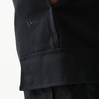 New Era Black Straight Leg Cargo Joggers, close-up view showing the textured fabric and the embroidered New Era flag logo above the flap of the side cargo pocket.