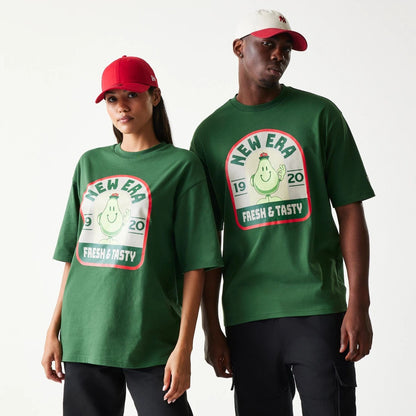The model is wearing this New Era Pear Fruit Graphic Oversized T-Shirt in dark green. 1