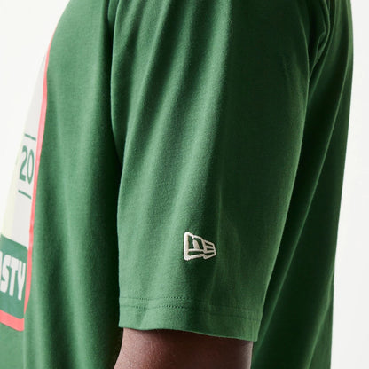 The model is wearing this New Era Pear Fruit Graphic Oversized T-Shirt in dark green. 7