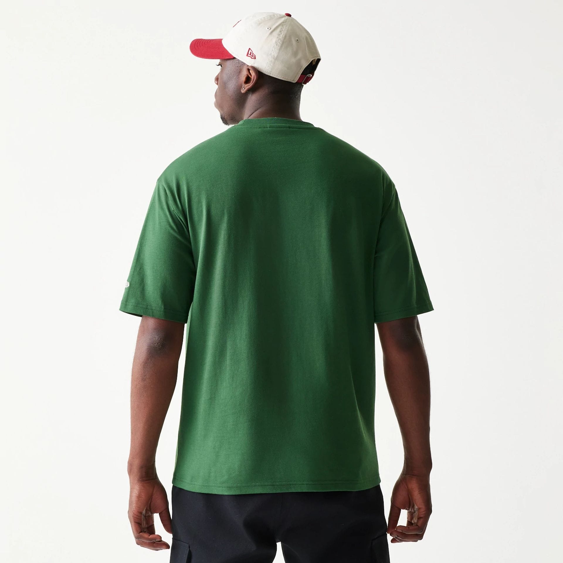 The model is wearing this New Era Pear Fruit Graphic Oversized T-Shirt in dark green. 2