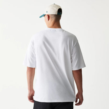 The model is wearing this New Era Baseball Player Graphic Oversized T-Shirt in white. 2