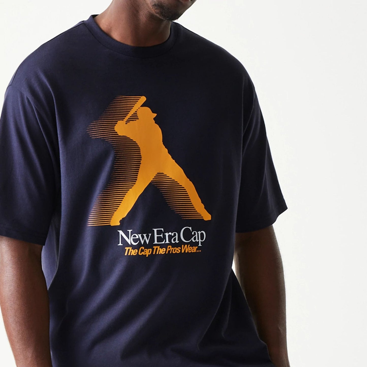 The model is wearing this New Era Baseball Player Graphic Oversized T-Shirt in navy. 3