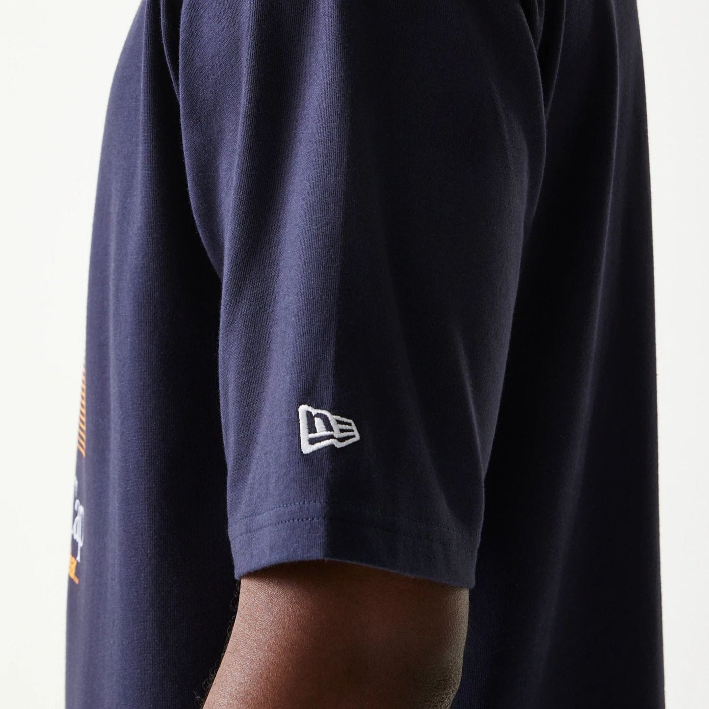 The model is wearing this New Era Baseball Player Graphic Oversized T-Shirt in navy. 5