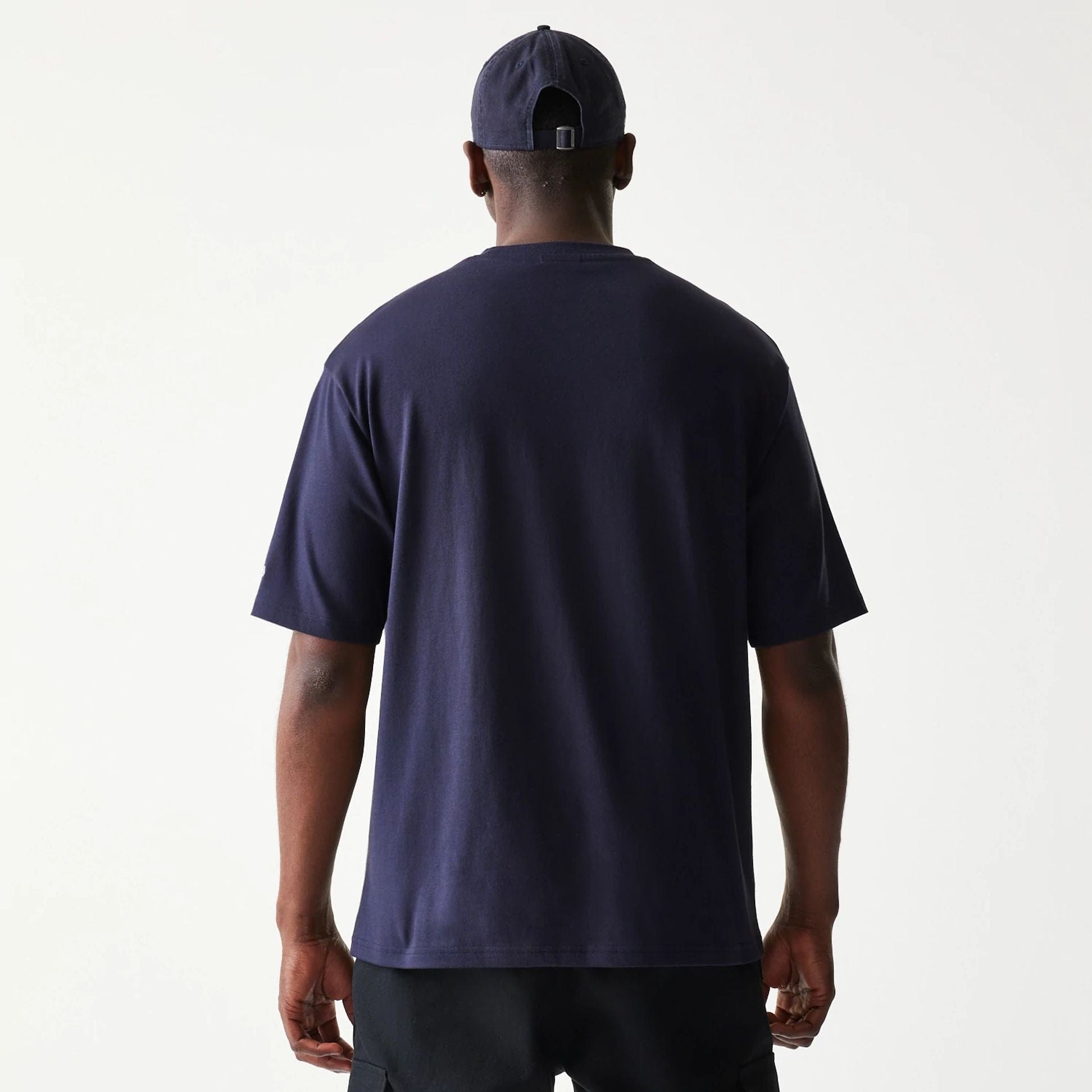 The model is wearing this New Era Baseball Player Graphic Oversized T-Shirt in navy. 2