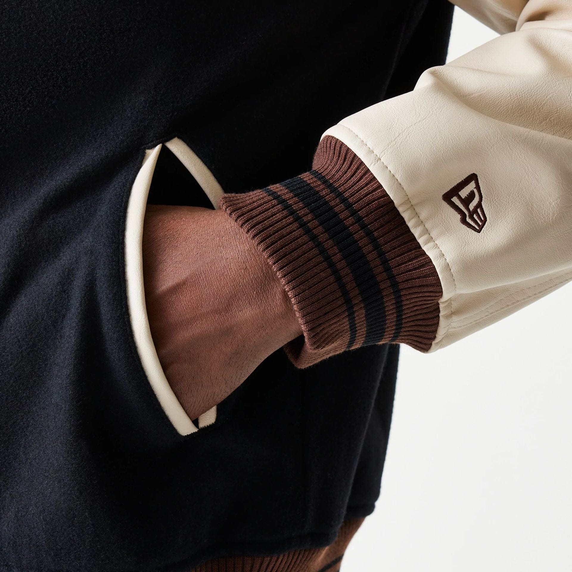 The model is wearing this New Era Varsity Jacket in black. 7