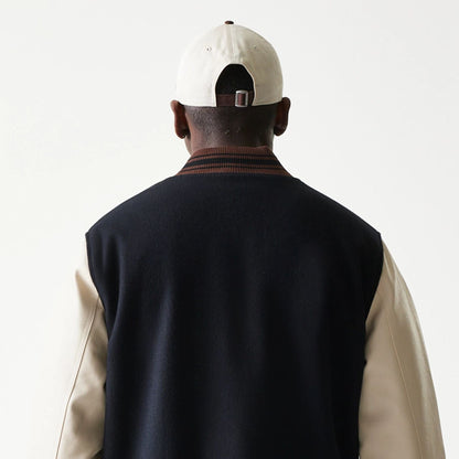 The model is wearing this New Era Varsity Jacket in black. 8