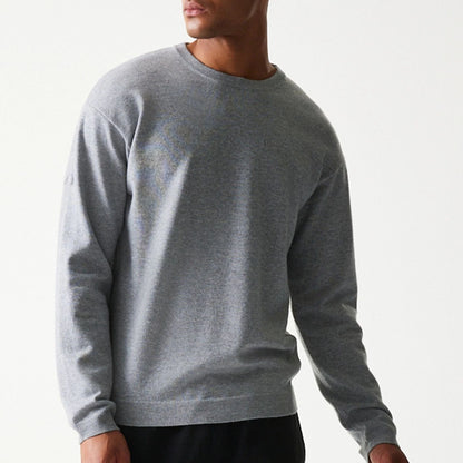 The model is wearing this New Era Essential Flag Knitted Sweater in grey. 5