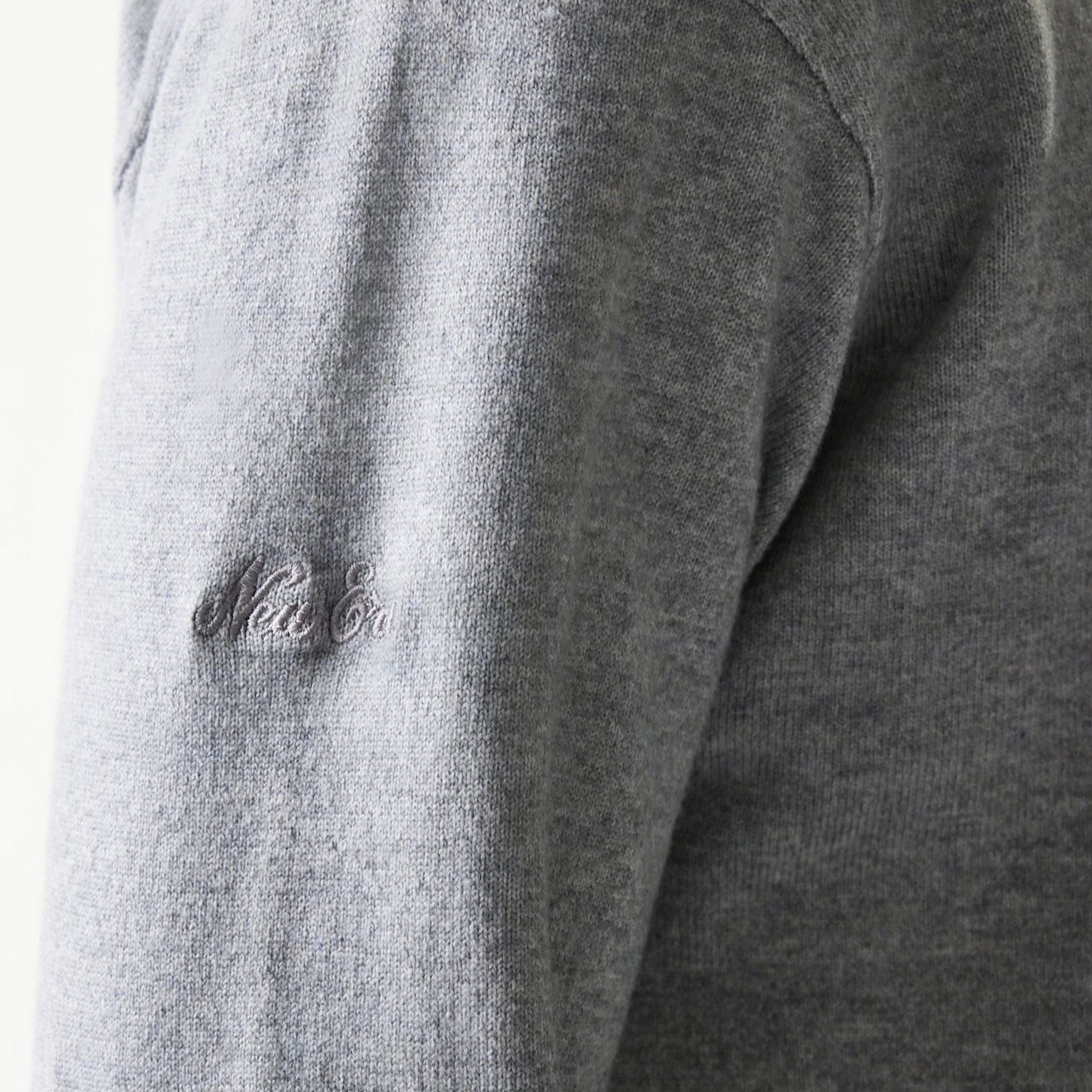 The model is wearing this New Era Essential Flag Knitted Sweater in grey. 8