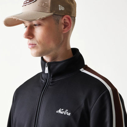 The model is wearing this New Era Script Track Jacket in black. 5