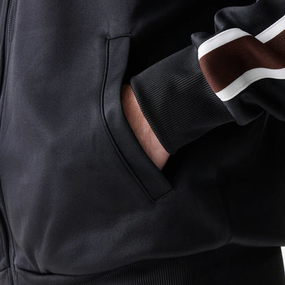 The model is wearing this New Era Script Track Jacket in black. 6