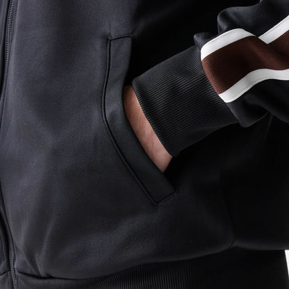 The model is wearing this New Era Script Track Jacket in black. 6