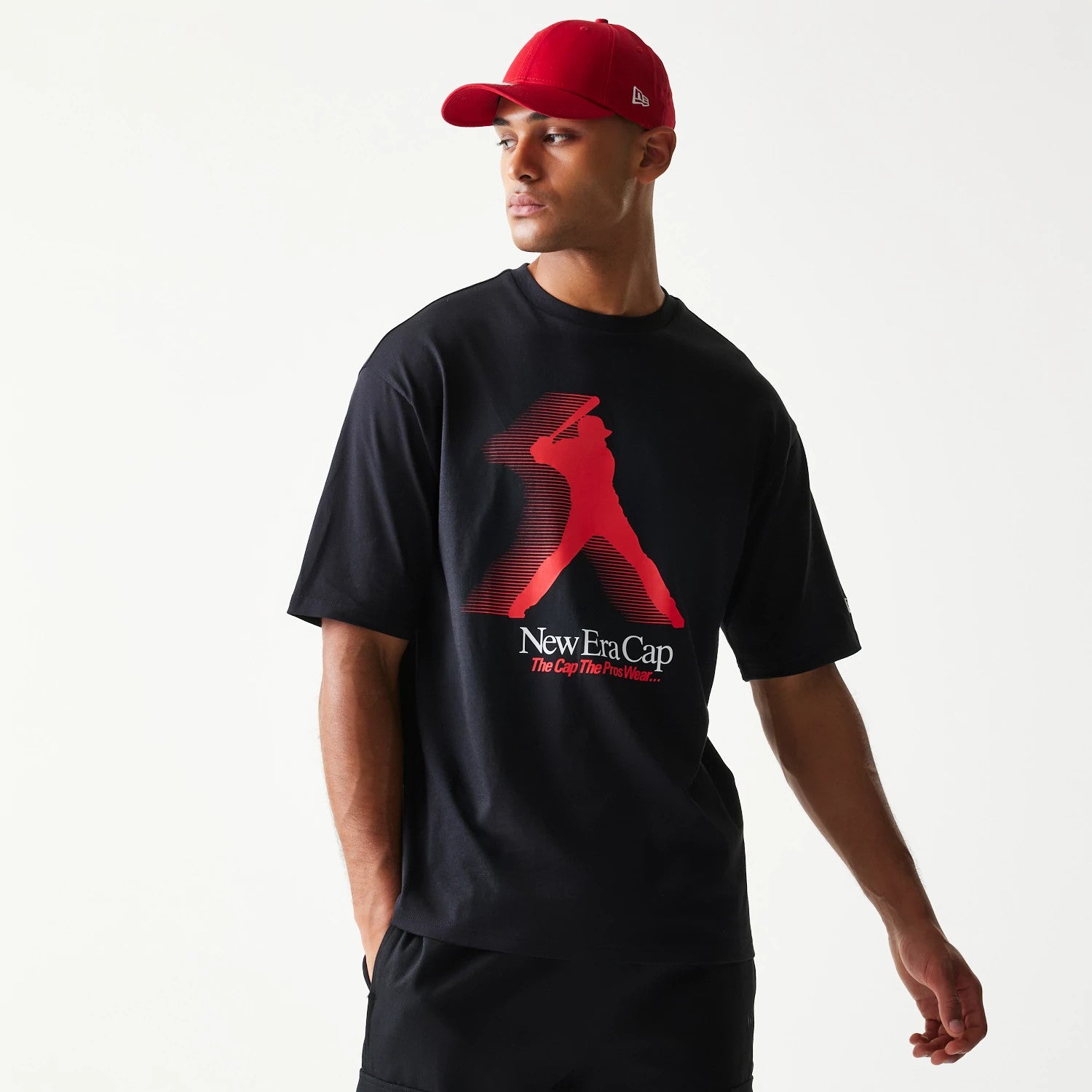 The model is wearing this New Era Baseball Player Graphic Oversized T-Shirt in black. 1