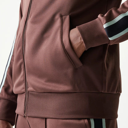 The model is wearing this New Era Script Track Jacket in brown. 7