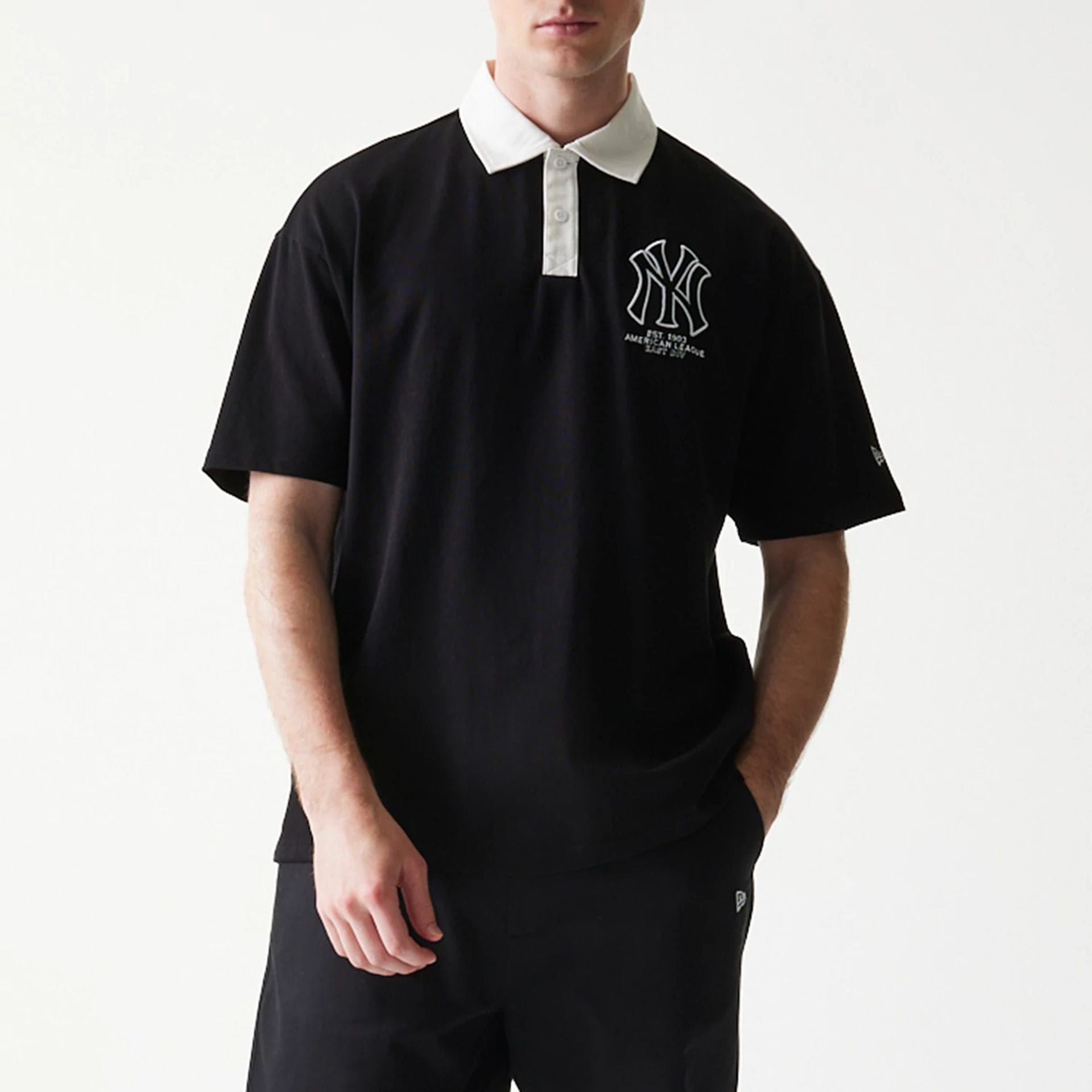 The model is wearing this MLB New York Yankees Oversized Polo T-Shirt in black. 3