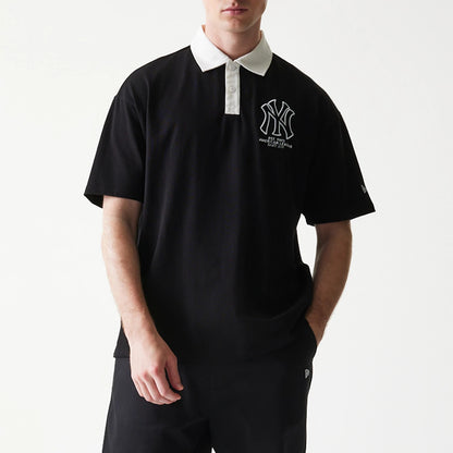 The model is wearing this MLB New York Yankees Oversized Polo T-Shirt in black. 3