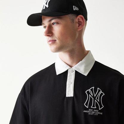 The model is wearing this MLB New York Yankees Oversized Polo T-Shirt in black. 4
