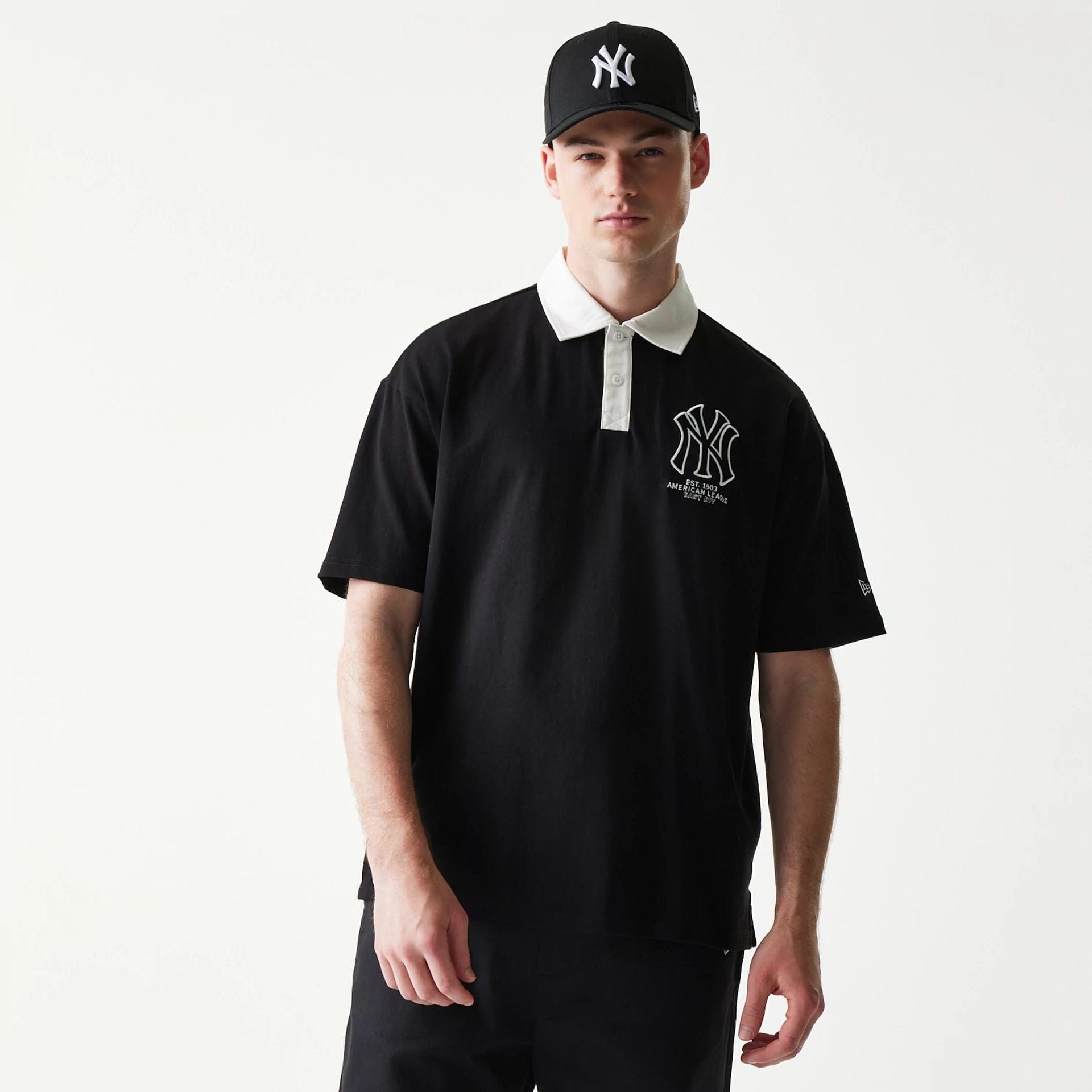 The model is wearing this MLB New York Yankees Oversized Polo T-Shirt in black. 1
