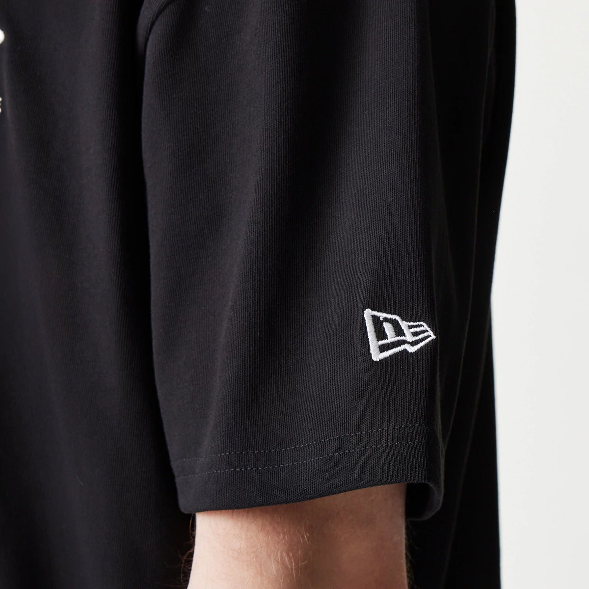 The model is wearing this MLB New York Yankees Oversized Polo T-Shirt in black. 5