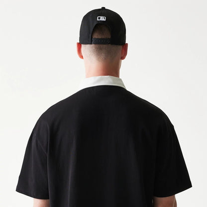 The model is wearing this MLB New York Yankees Oversized Polo T-Shirt in black. 7