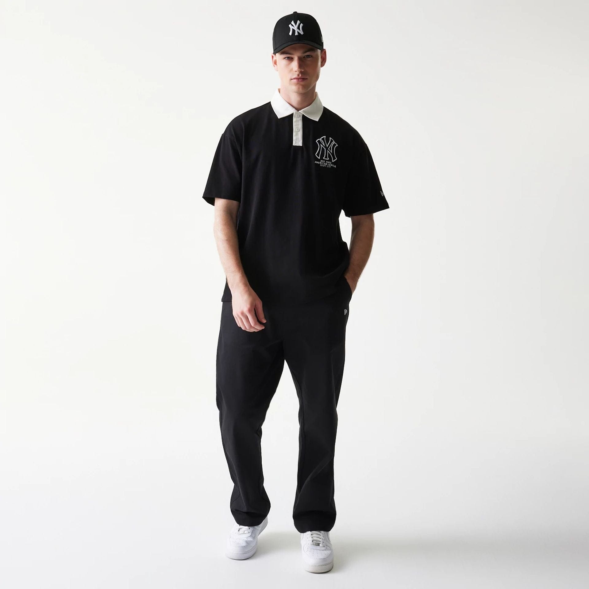 The model is wearing this MLB New York Yankees Oversized Polo T-Shirt in black. 8
