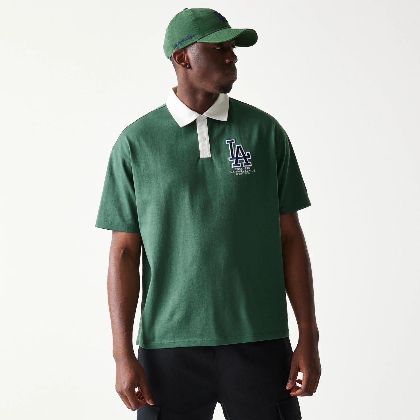 The model is wearing this MLB LA Dodgers Oversized Polo T-Shirt in dark green. 1